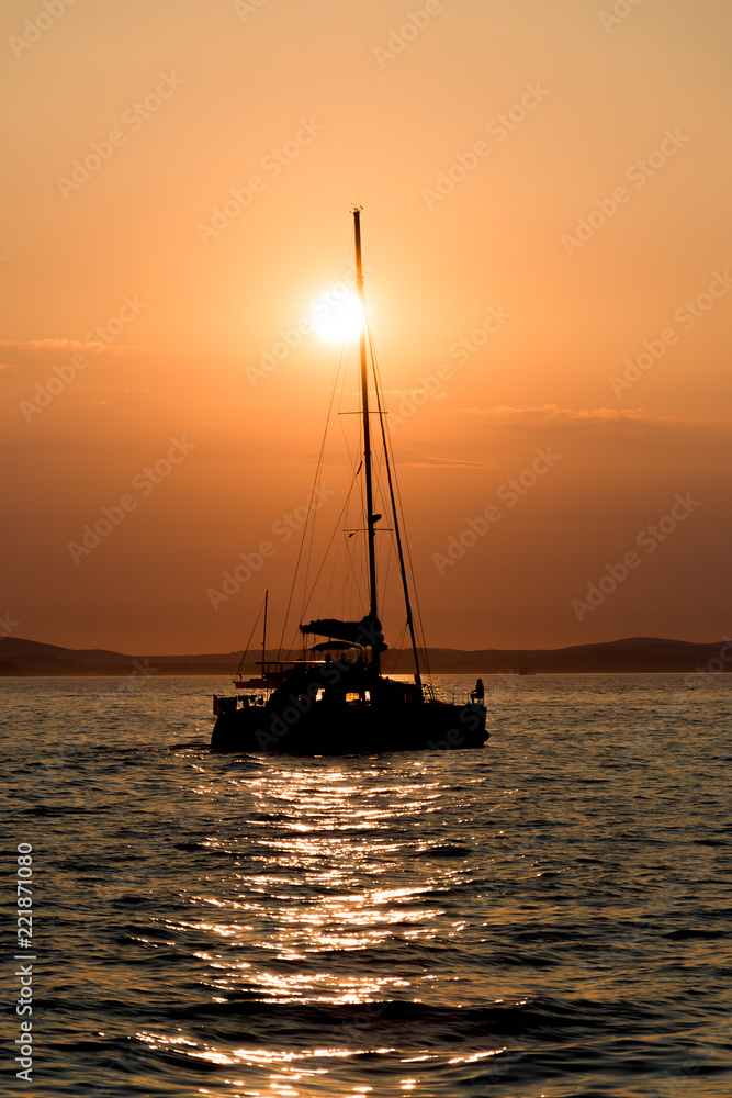 Silhouette of a sailboat at sunset in Zadar, Croatia