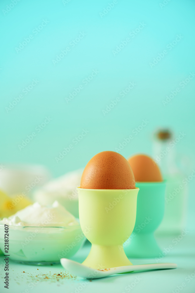 Bakery food frame, cooking concept. Different baking ingredients - butter, sugar, flour, milk, eggs, oil, spoon, rolling pin, brush, whisk over blue background. Copy space Bakery food frame, cooking concept. Different baking ingredients - butter, sugar, flour, milk, eggs, oil, spoon, rolling pin, brush, whisk over blue background. Copy space