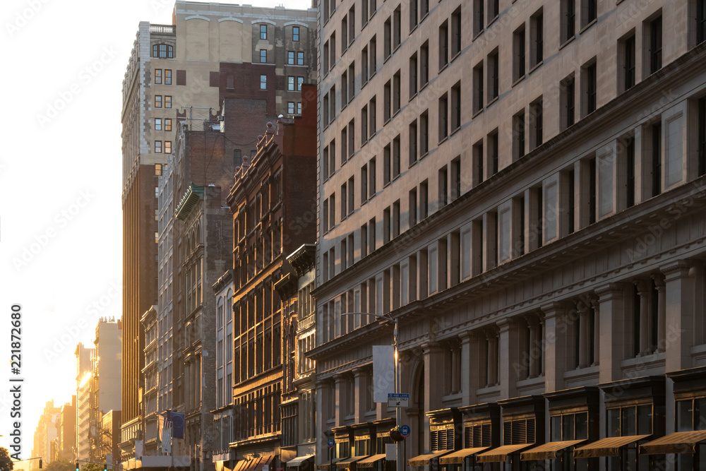 Warm light of sunset shines on the buildings along 23rd Street in Manhattan, New York City