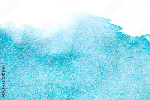 Abstract hand painted blue watercolor splash on white paper background