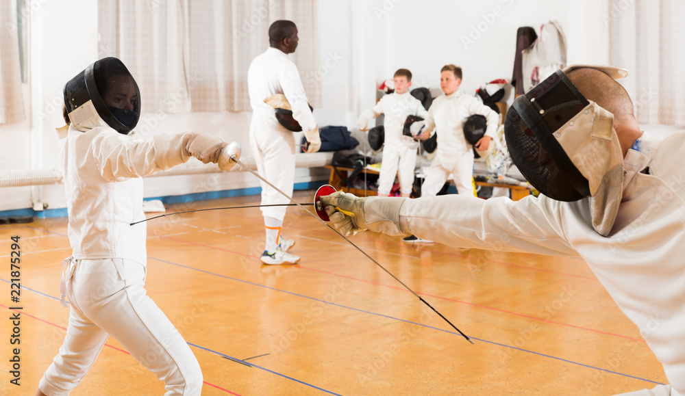 Modern group  practicing fencing techniques