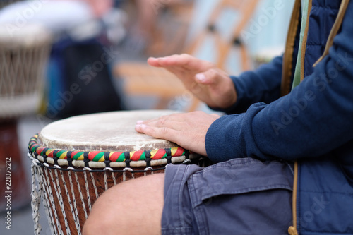 Hands of a musician playing on an African djembe drum, at a percussion music festival