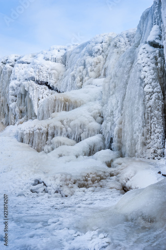 Frozen cascade of waterfall. Winter background. Jagala Waterfall, Estonia. Soft focus.