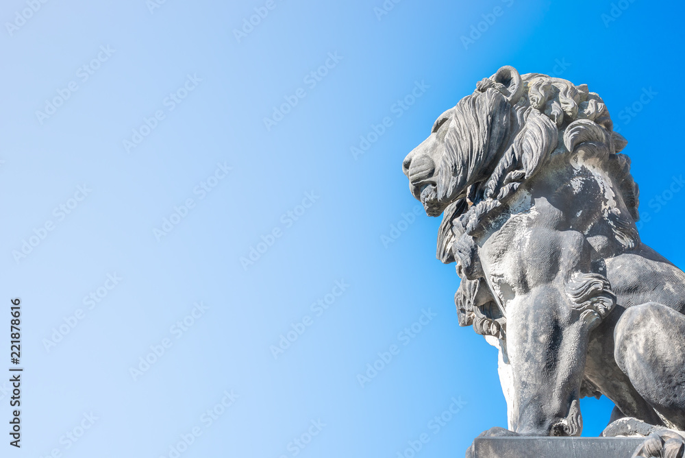 Statue of lion near cathedral in Magdeburg at smooth gradient background, Germany