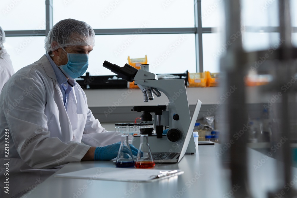 Male scientist using microscope Male scientist using microscope