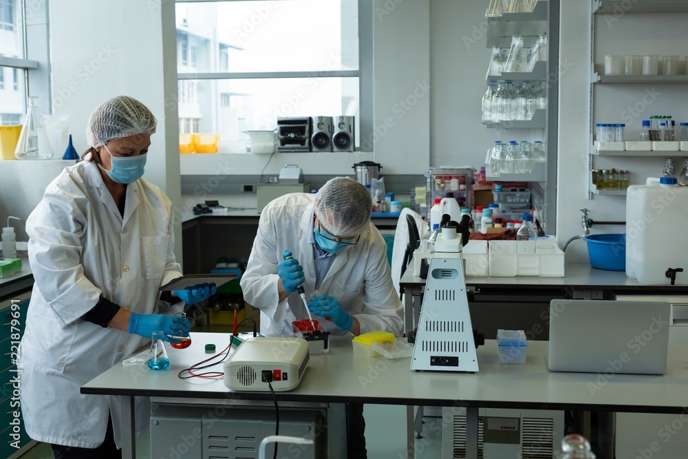 Scientists experimenting in laboratory Scientists experimenting in laboratory