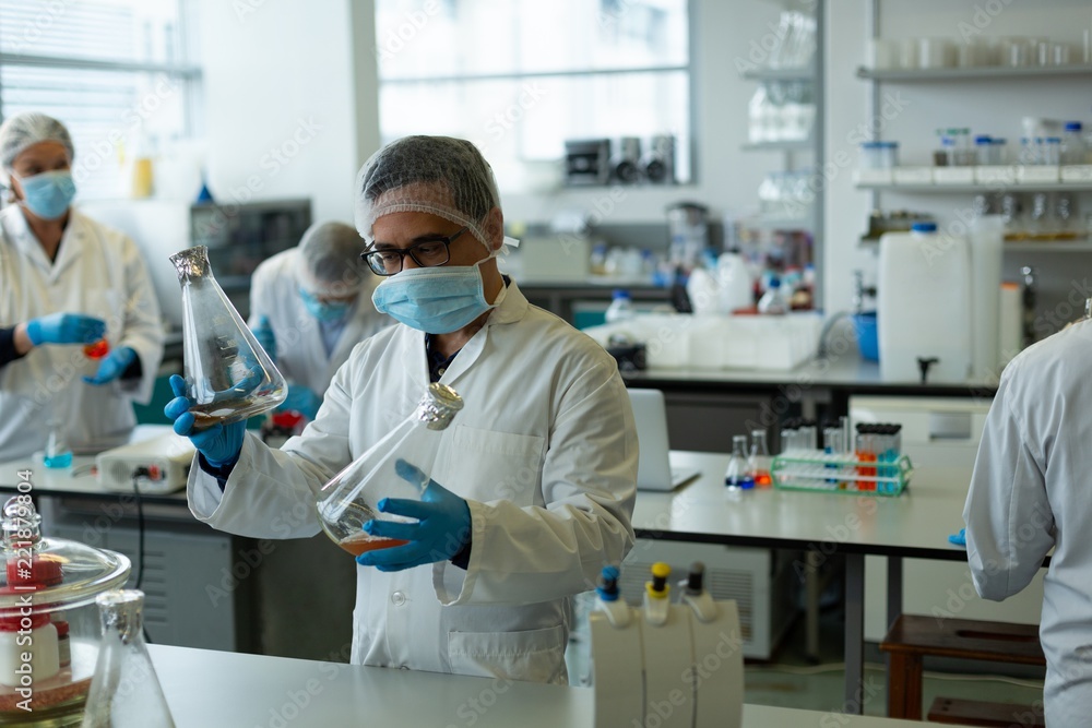 Scientists experimenting in laboratory Scientists experimenting in laboratory