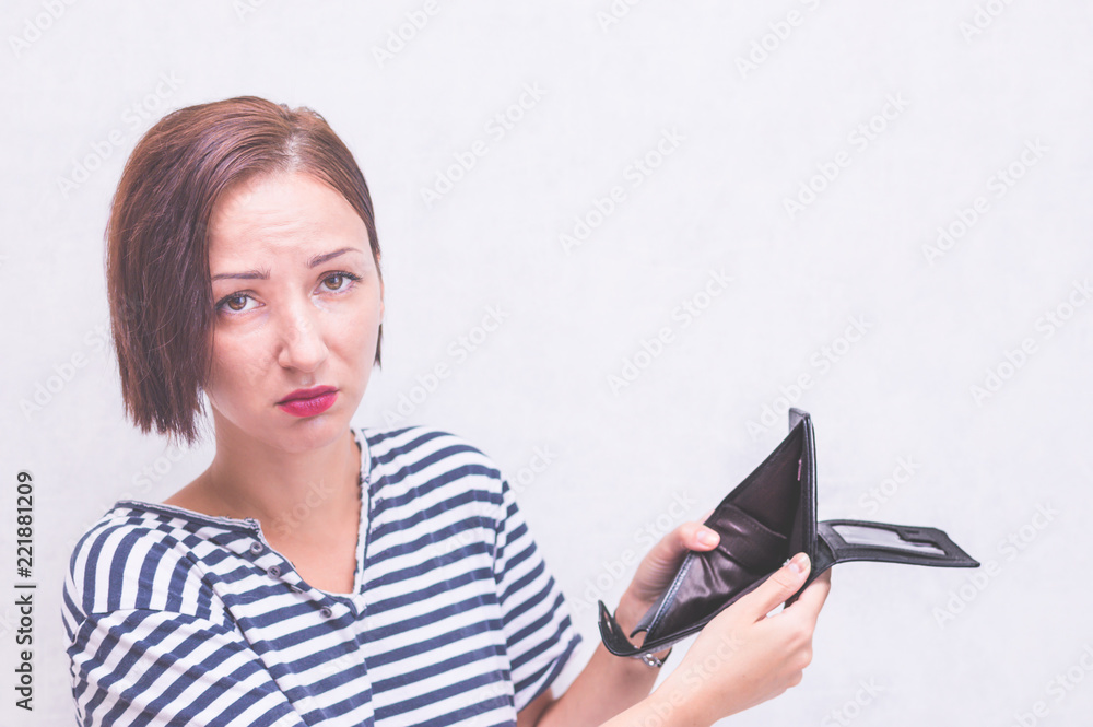 Woman with an empty wallet. Concept lack of money Woman with an empty wallet. Concept lack of money