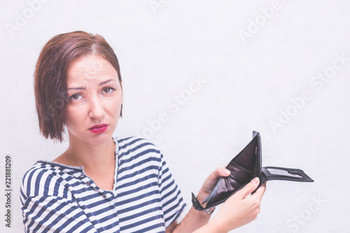 Woman with an empty wallet. Concept lack of money