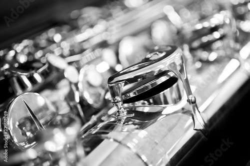 Fragment of the saxophone valves closeup in black and white