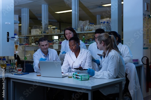 Team of scientist using laptop in laboratory photo