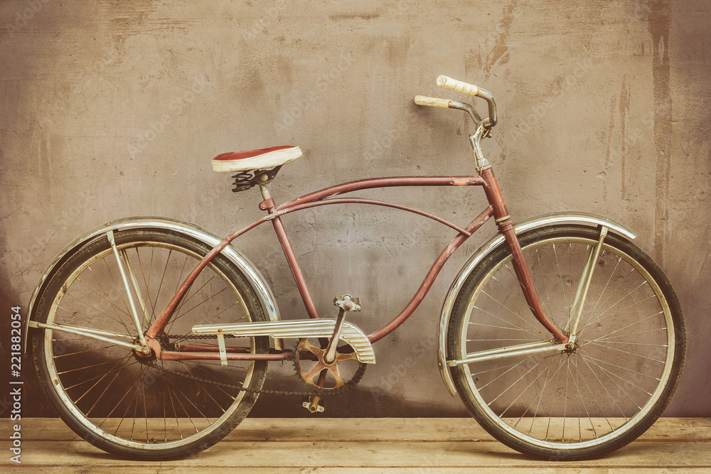 Vintage rusted cruiser bicycle on a wooden floor