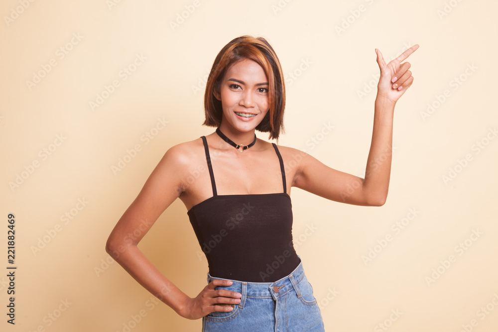 Young Asian woman smile and point. Young Asian woman smile and point.