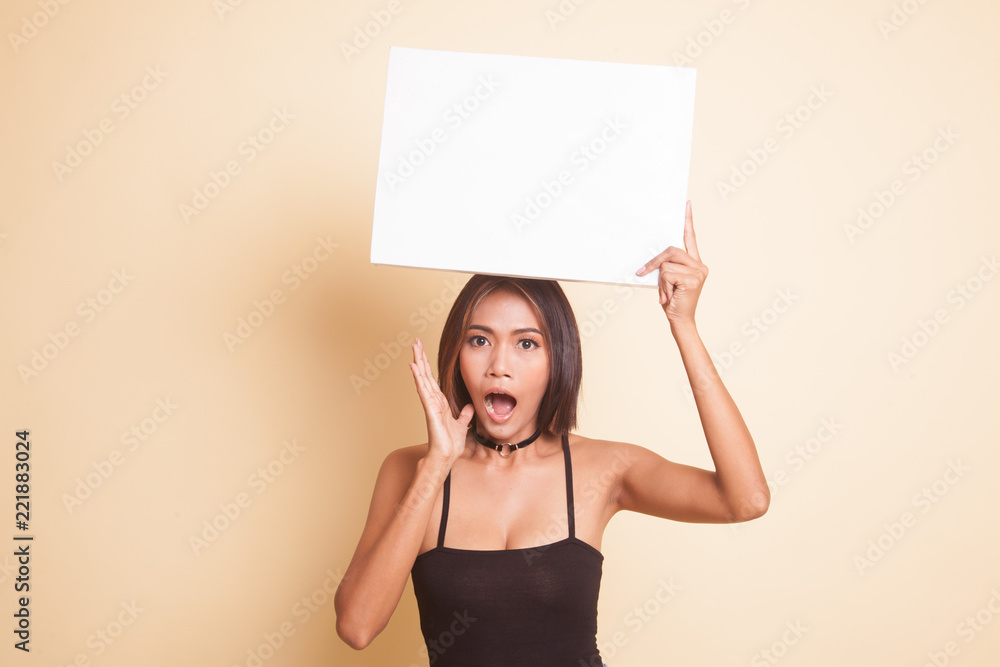 Young Asian woman surprise with white blank sign. Young Asian woman surprise with white blank sign.