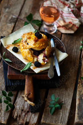 Baked brie with blackberry in puff pastry.style rustic