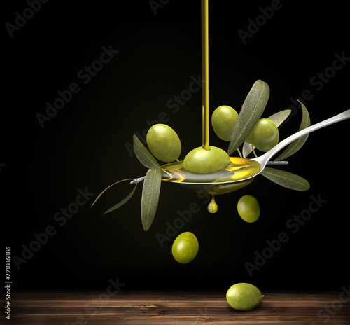Olive oil jet over a olive branch in a spoon