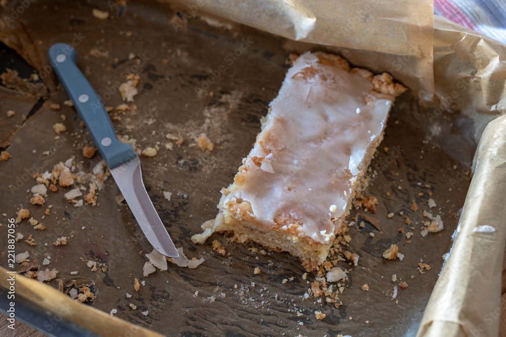 Fototapeta premium Cake with the addition of tasty ripe apples. The last piece of sweet dessert on a baking tray.