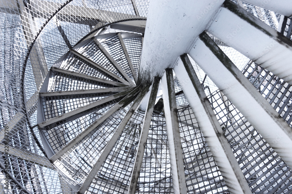 Obraz premium swirling metal staircase leading down, descending the stairs to the bottom