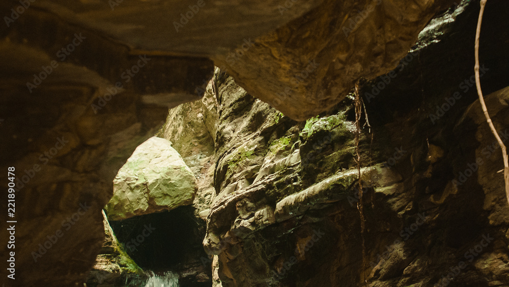 Stone Cave entrance. Cave hole inside, Close up of waterfall Stone Cave entrance. Cave hole inside, Close up of waterfall