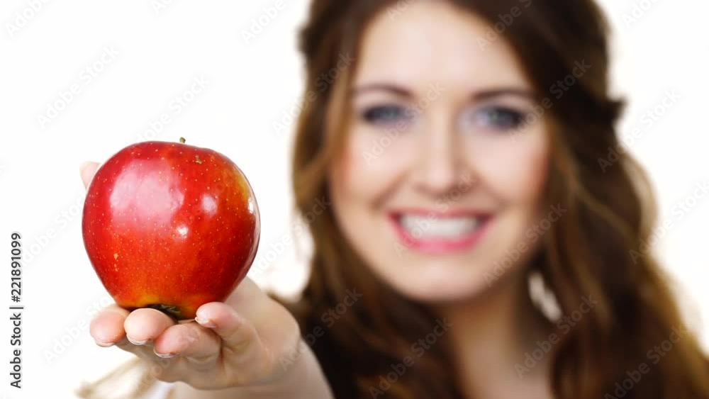 Young brunette woman recommend healthy eating diet, holding red apple in hand, focus on fruit, isolated on white Young brunette woman recommend healthy eating diet, holding red apple in hand, focus on fruit, isolated on white