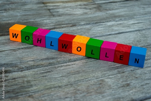 Farbige Holzwürfel mit Buchstaben auf dem das Wort Wohlwollen abgebildet ist, Abstrakte Illustration photo