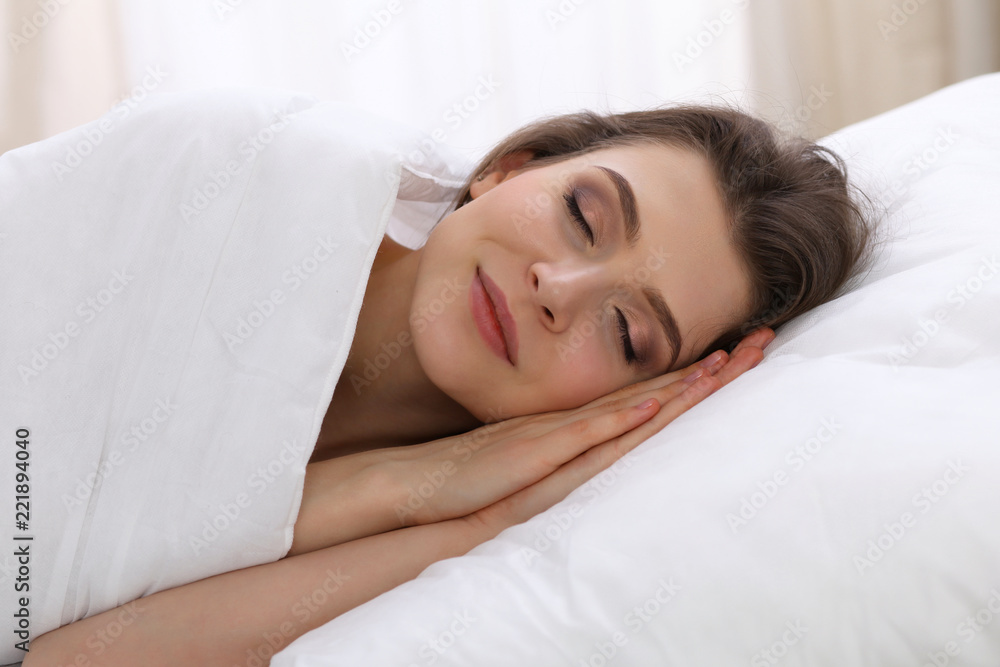 Beautiful young woman sleeping while lying in her bed. Concept of pleasant and rest reinstatement for active life Beautiful young woman sleeping while lying in her bed. Concept of pleasant and rest reinstatement for active life
