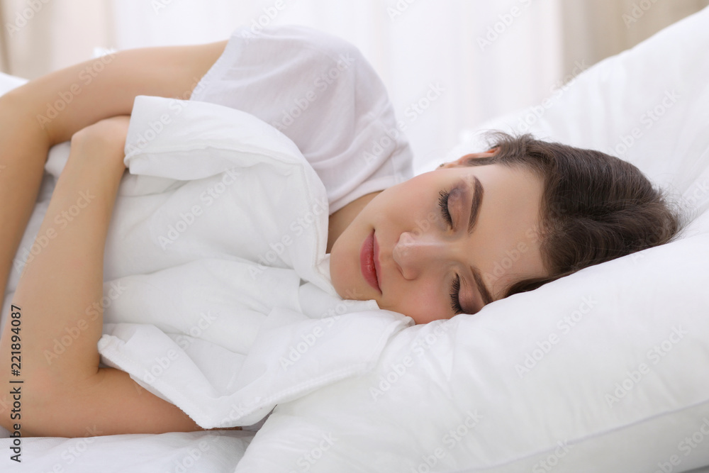 Beautiful young woman sleeping while lying in her bed. Concept of pleasant and rest reinstatement for active life Beautiful young woman sleeping while lying in her bed. Concept of pleasant and rest reinstatement for active life