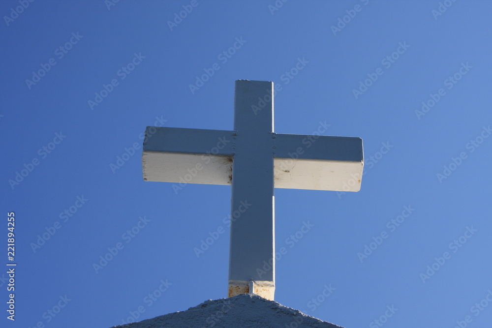 Cycladic greek orthodox church on Paros island, Greece. White cross against blue sky