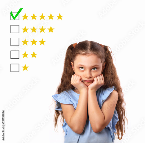 The best rating, evaluation, online rewiew. Business thinking stress kid girl voting to five yellow star to increase ranking isolated on white background photo