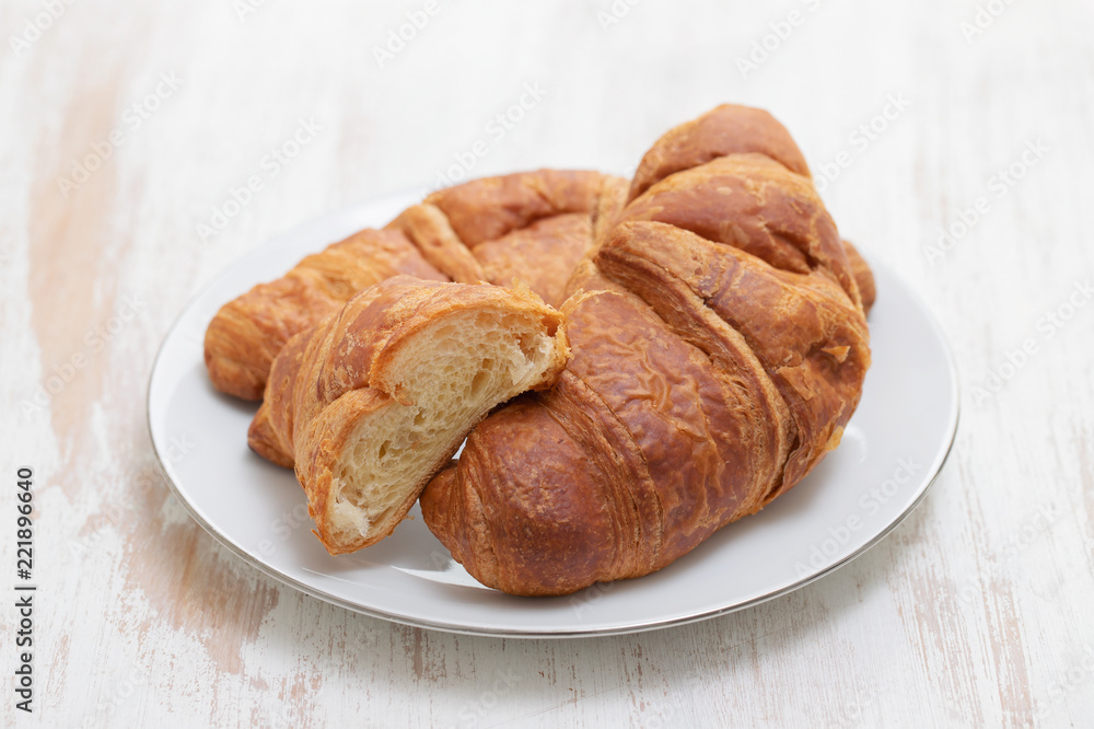 croissant on white dish on white wooden background