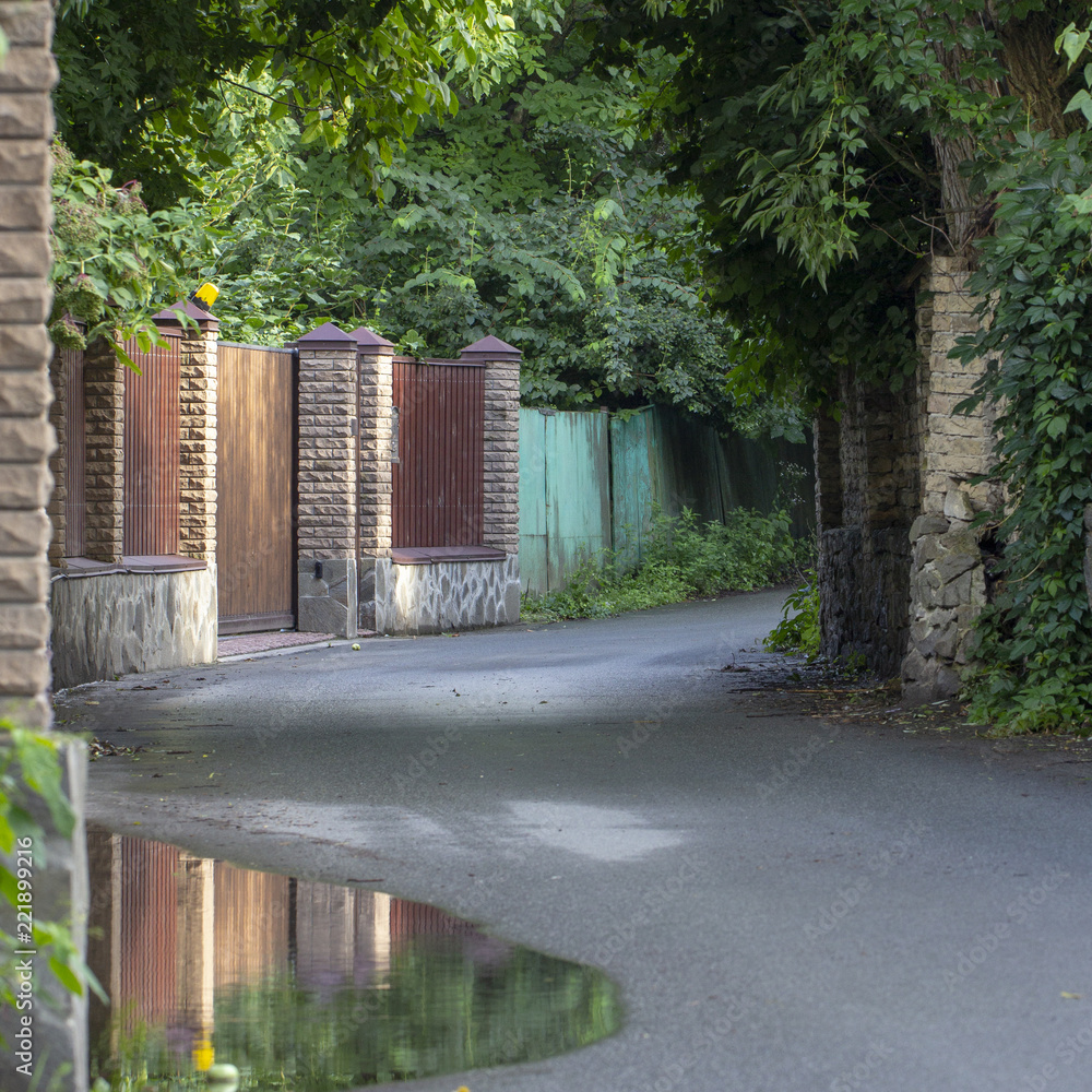 Very narrow rural street in the village of Stary Petrovtsi, Kiev region, Ukraine Very narrow rural street in the village of Stary Petrovtsi, Kiev region, Ukraine