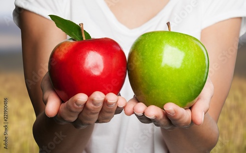 Woman holding two apples isolated on  background