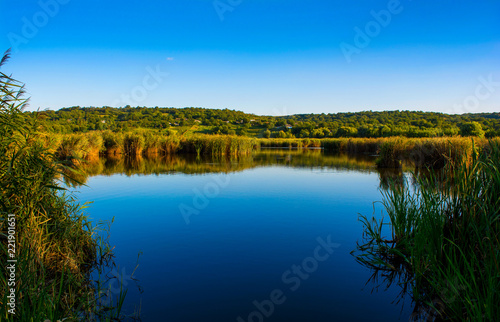 Photo of nature around beautiful blue lake, fishing place