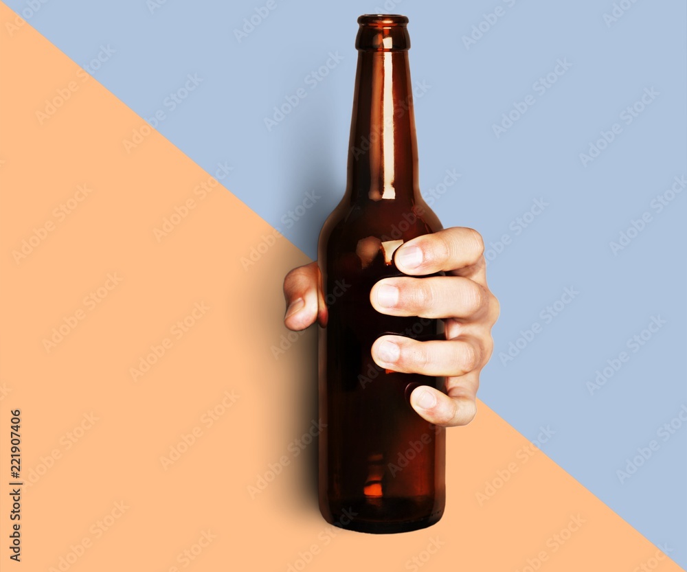 Hand holding beer bottle without label isolated on white - obrazy, fototapety, plakaty 