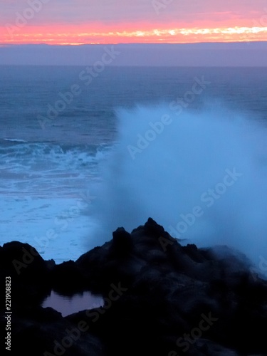 Thundering shores surf crashing on rocky shoreline at sunset Oregon coast