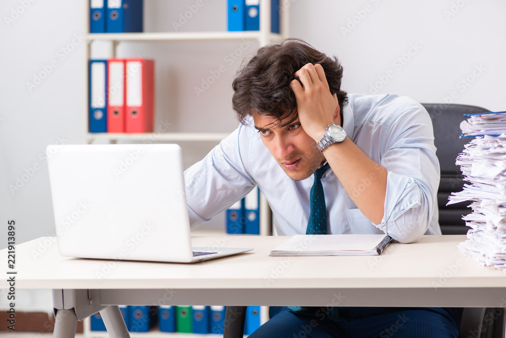 Overloaded busy employee with too much work and paperwork