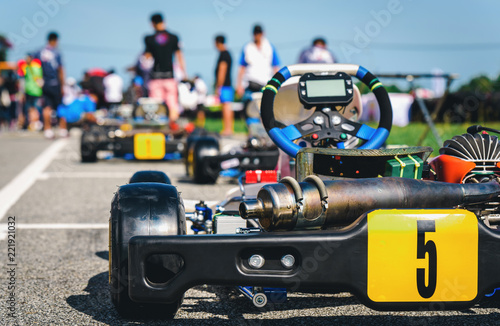 Kart racing park is the starting point for a team of racers at a blurred background.