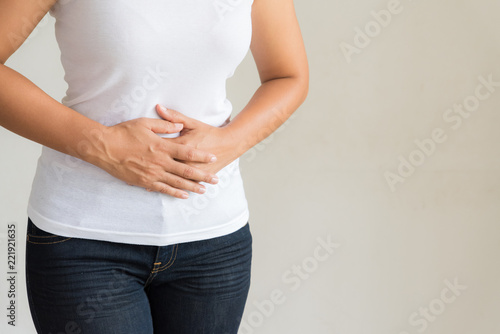 Young woman having painful stomachache. Chronic gastritis. Abdomen bloating concept.