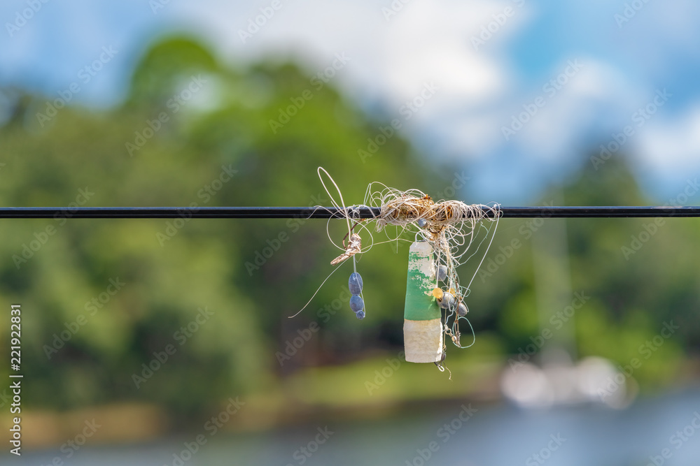 fishing line, weights, float/bobber hooks tangled in power line Stock Photo