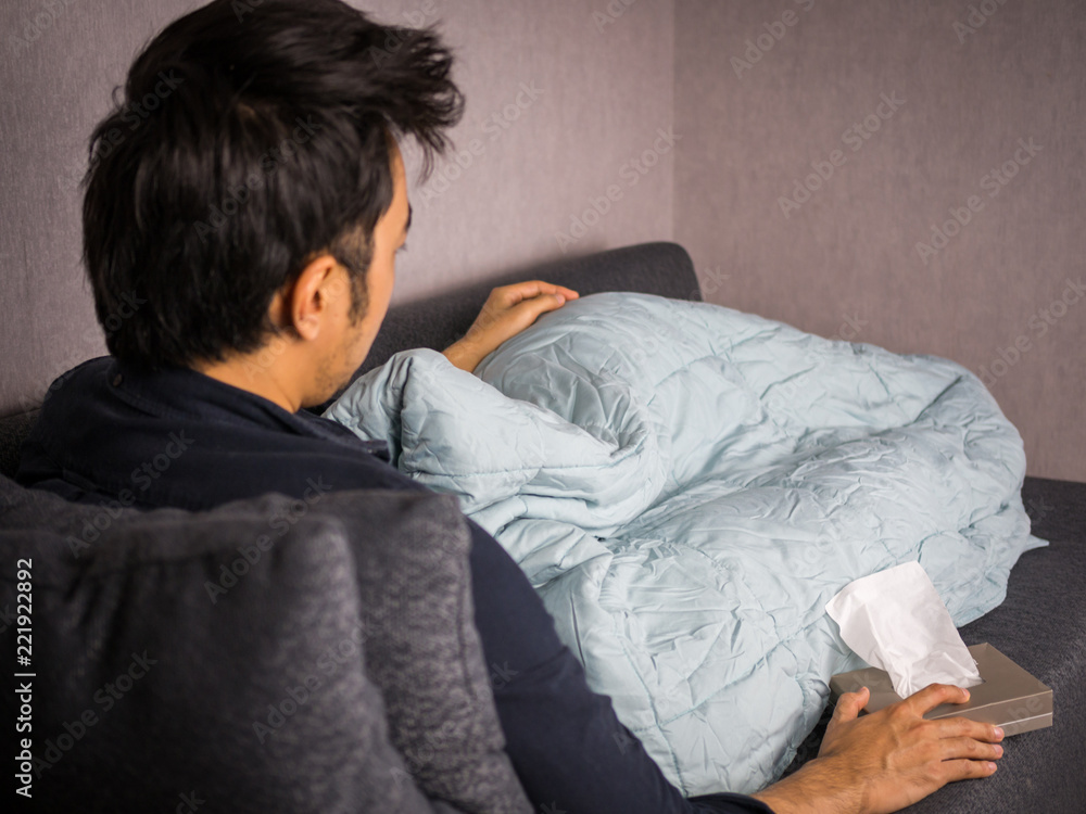 Man on sick bed with tissue paper and blanket Man on sick bed with tissue paper and blanket