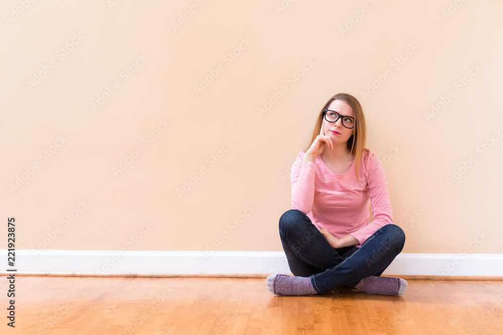 Young woman thinking about something in a big room Young woman thinking about something in a big room