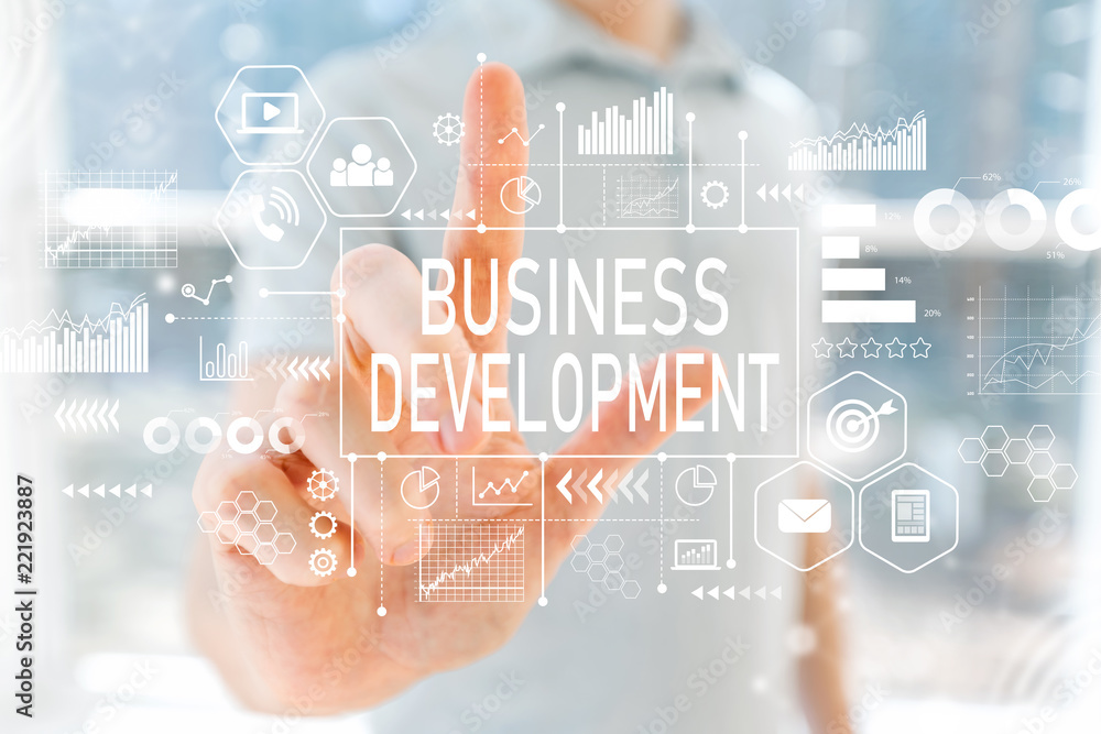 Business Development with young man in front of windows Business Development with young man in front of windows