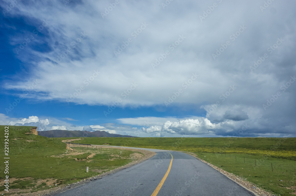 Road crossing meadows and fields in Qinghai, China