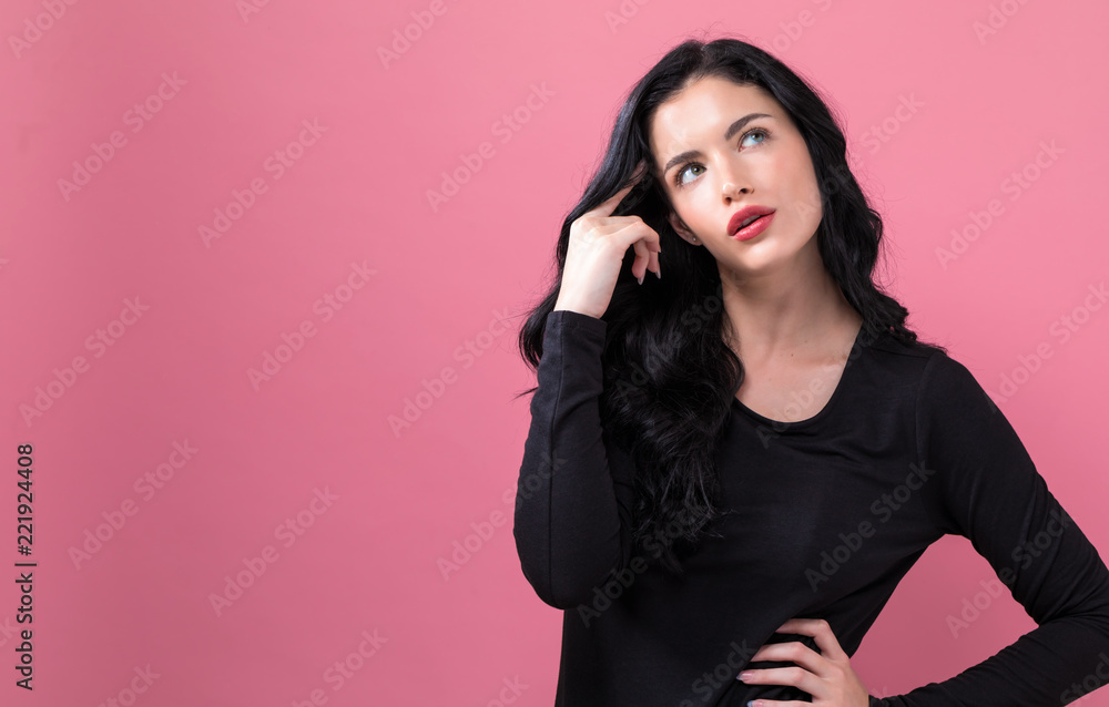 Young woman in a thoughtful pose on a solid background Young woman in a thoughtful pose on a solid background