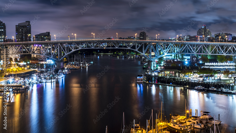 Granville Bridge along False Creek long exposure at night Vancouver BC. Vancouver is the third most populous metropolitan area and is the most ethnically diverse cities in Canada.