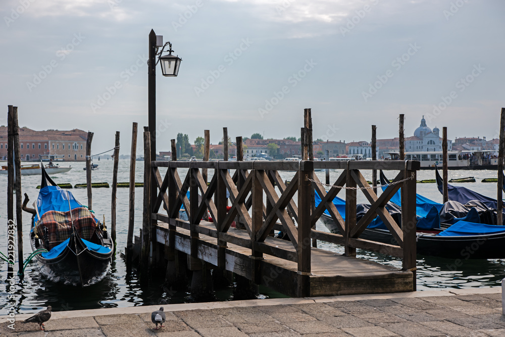 gondolas on grand canal in venice at the pier