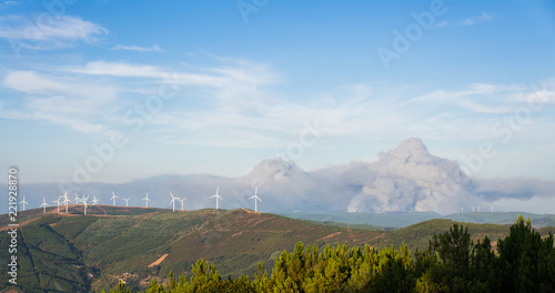 Smoke in a valley in Portugal as the wildfires come close to the wind turbines photo