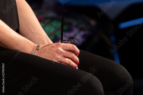 Close up of hands of an alcoholic woman