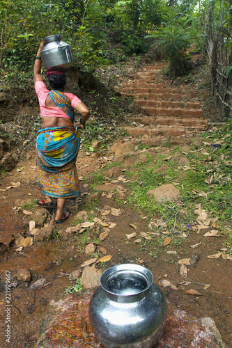 MAHARASHTRA, INDIA, April 2013, Woman carries a water from a stream. photo