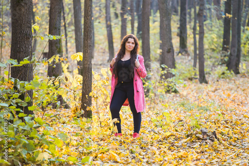 Autumn  nature and people concept - Portrait of beautiful smiling plus size woman walking in fall